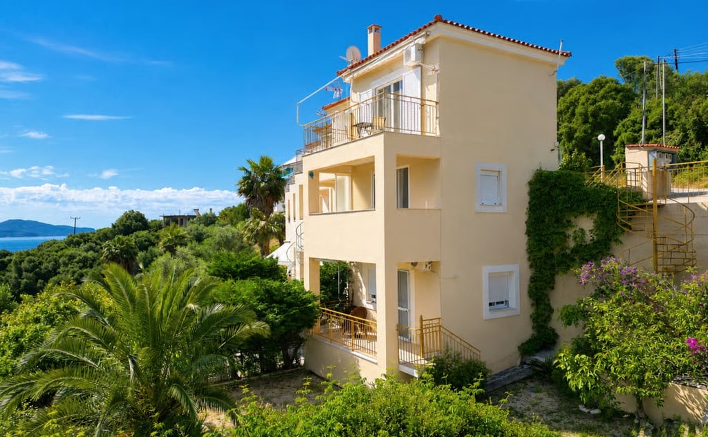 Affordable Greece property under €250,000 with balconies, sea views and established Mediterranean planting.