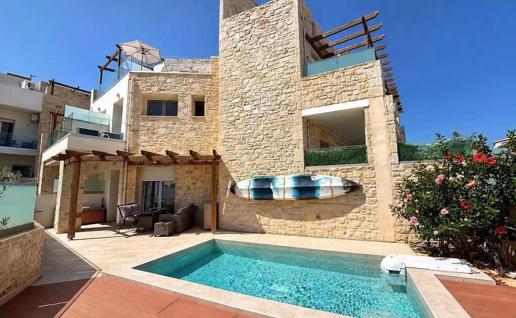 Affordable Greece property under €250,000 with stone walls, outdoor terraces and a private swimming pool.