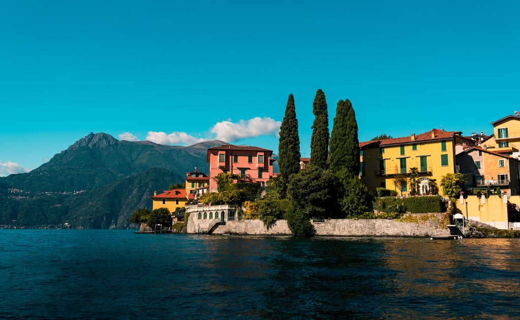 Lakeside homes on Lake Como with mountains behind, showing premium northern Italy property locations