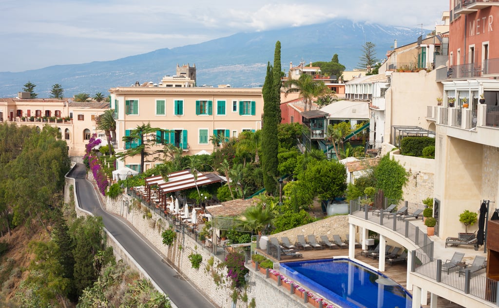 Homes and terraces in Sicily with Mount Etna behind, showing island towns for international buyers