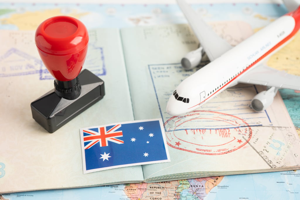 Passport with toy plane, Australia flag and visa stamp
