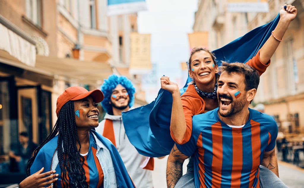 Football fans walk through city street in team colours during World Cup 2026 host city week
