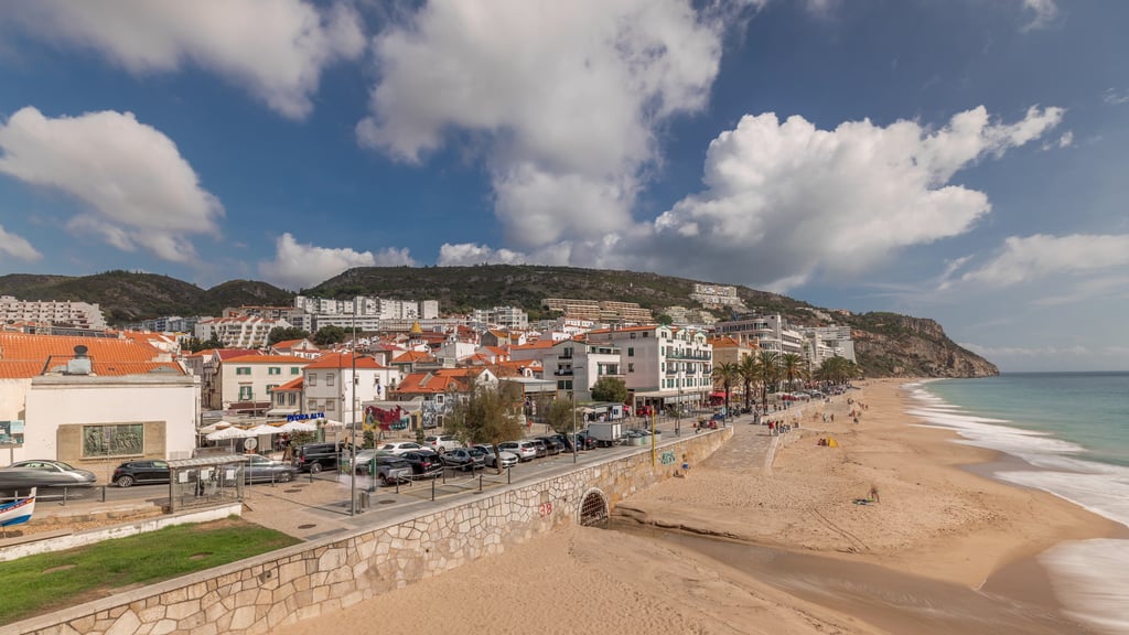 Aerial view of Sesimbra town and its beach, one of the affordable places to buy near Lisbon on the coast