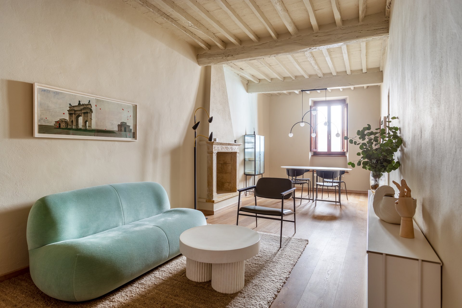 Living room after renovation with restored beams, new floors and custom furnishing