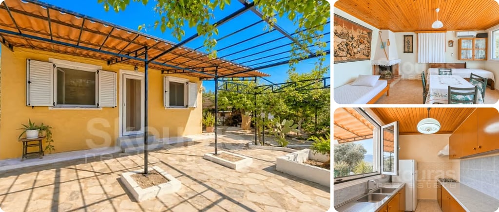 Ochre-yellow Astros house with white shutters and an orange pergola over a stone-paved terrace, with trees behind