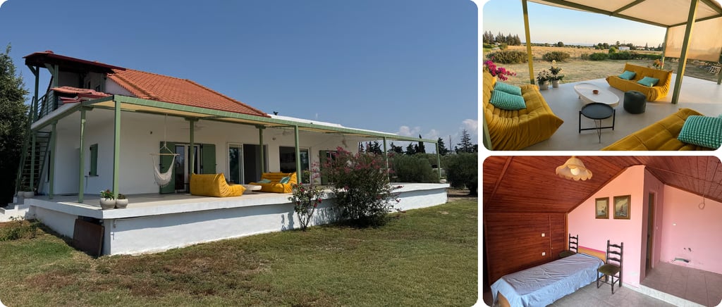White house with an orange tiled roof and a wide covered veranda with yellow sofas on a grassy plot in Epanomi