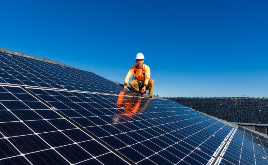An engineer installs solar panels