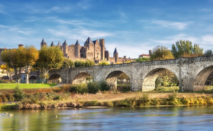 Carcassonne and the Le Pont Vieux bridge viewed from across the Aude river