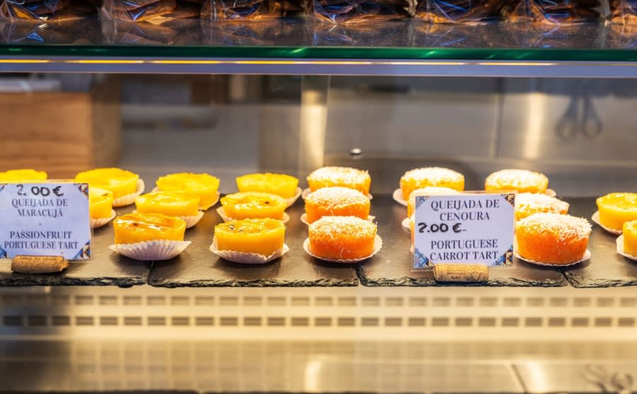 Display of a candy shop with queijada in Bolhao Market street food market in Porto or Oporto Portugal