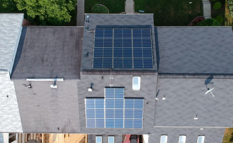 An aerial view of a new build house with solar panels