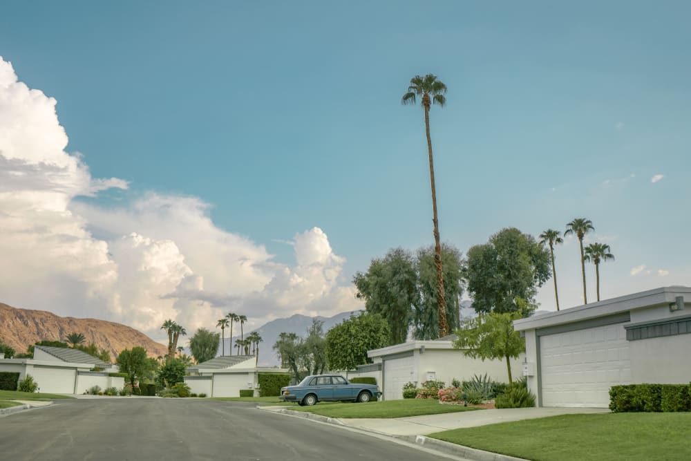 Sunny day at Palm Springs with mountains and palm trees. Beautiful view of hills. Iconic architecture. California style.