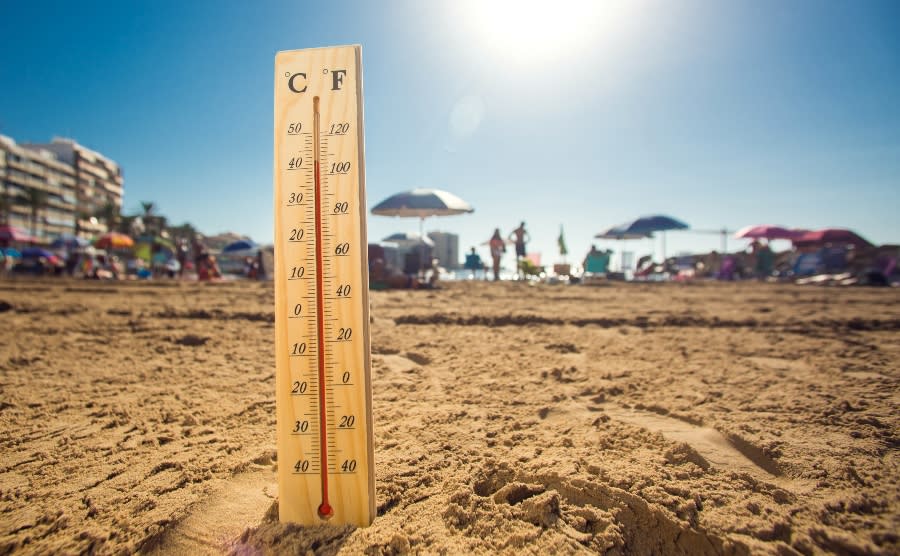 Thermometer on the beach showing high temperatures
