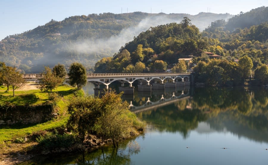 A beautiful photo of a bridge over the Cavado River with reflections in Peneda-Geres National Park, Portugal