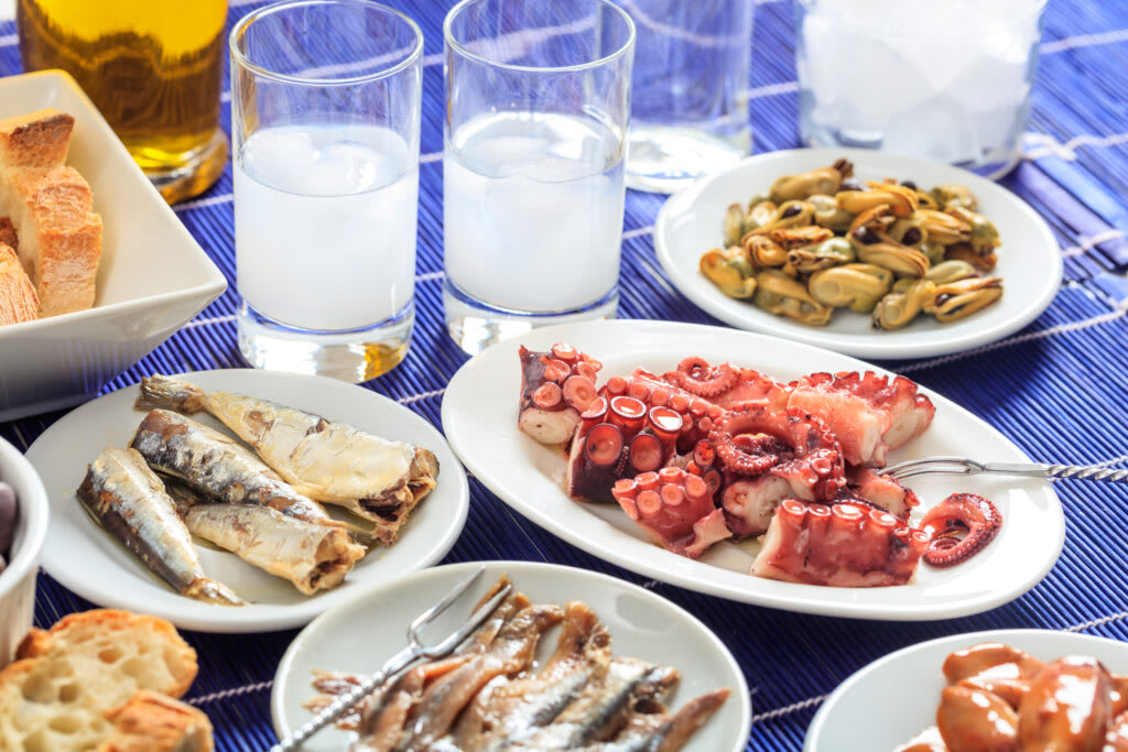 Grilled octopus, sardines, anchovies and mussels laid out as a seafood meze spread