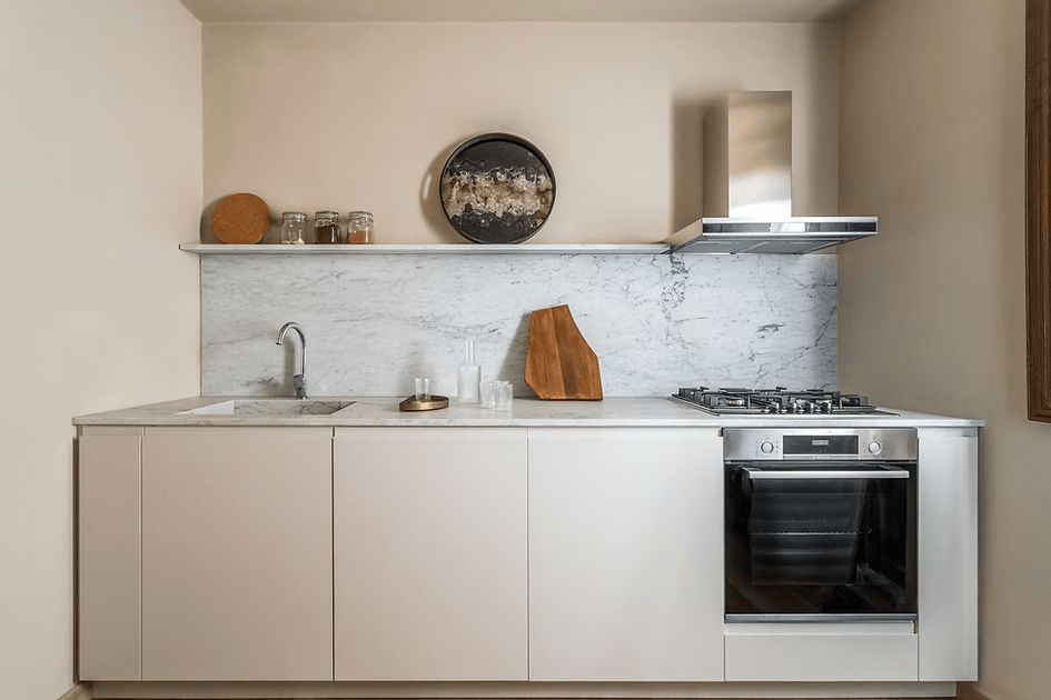 Kitchen after renovation, with Carrara marble splashback and worktop